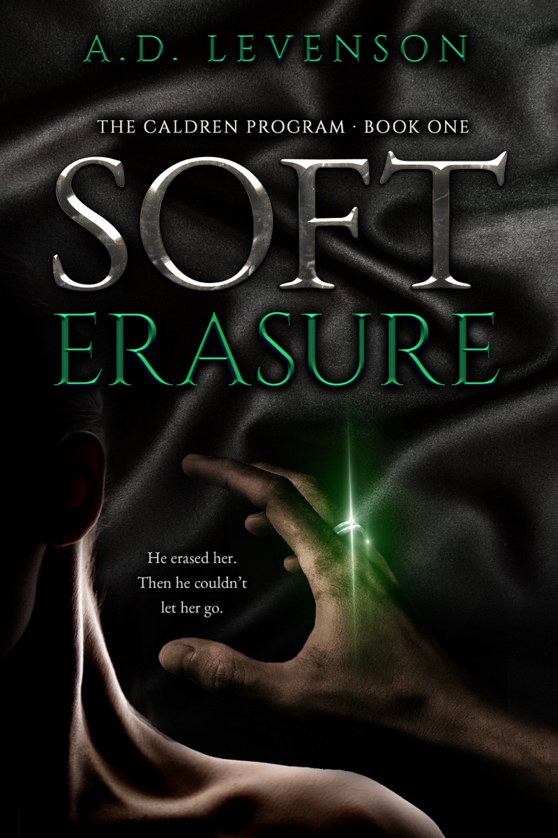 Soft Erasure by A.D. Levenson. Book one of The Caldren Program. A woman's face in profile against black satin, a hand reaching toward her, a ring throwing green light between them.